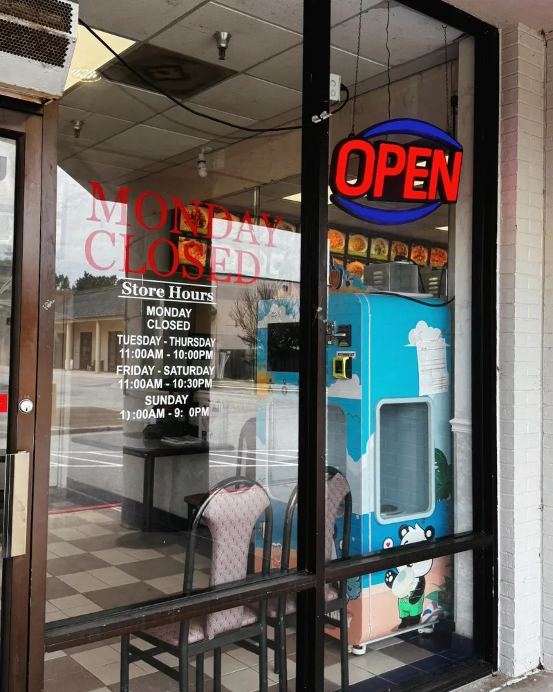 Glass entrance door showing business hours and open neon sign at China Chef Restaurant, a Chinese Restaurant in Daphne